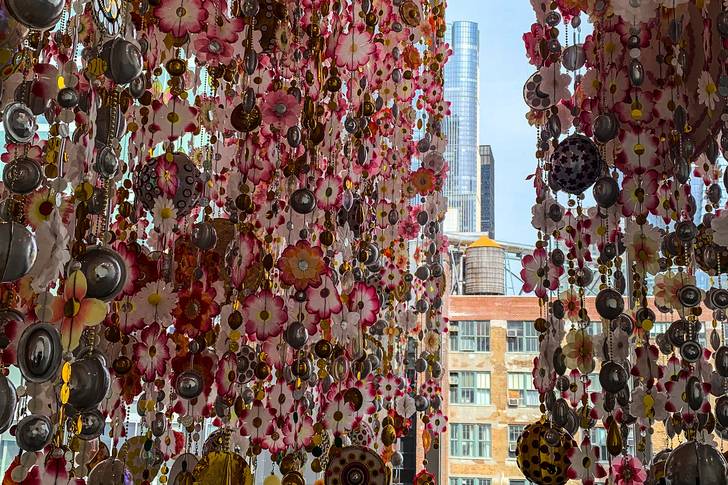 dangling flower curtains with a tall apartment building in the background